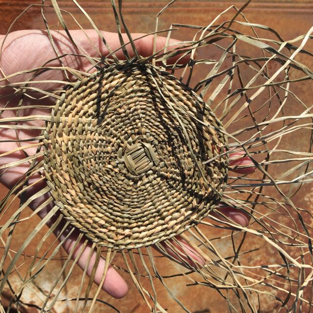 Handwoven grass baskets arranged on the ground
